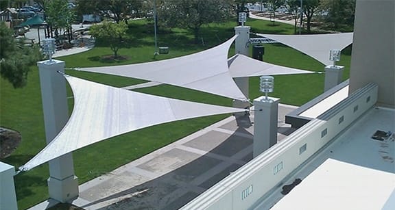 Shade sails covering an outdoor cement patio