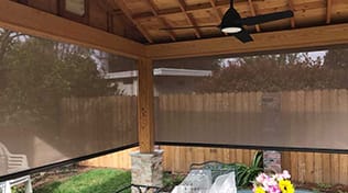 view from inside a patio with outdoor roller shades