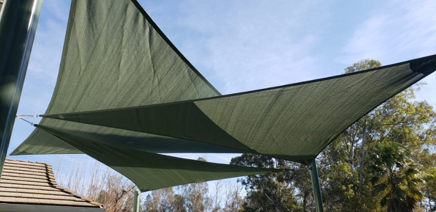 Transform your backyard into an oasis of relaxation and comfort with the installation of beautiful green shade sails.